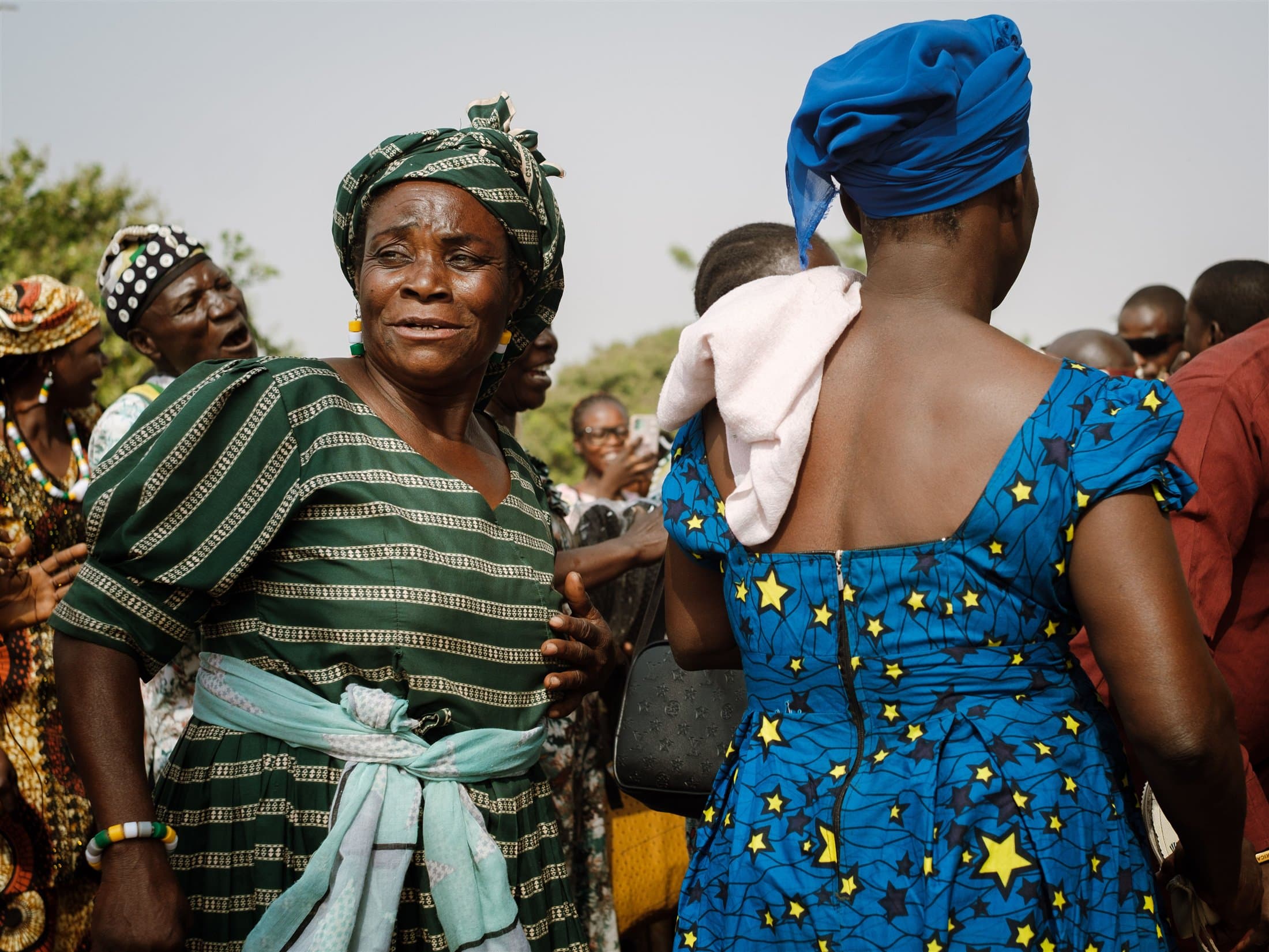 Women in vibrant traditional clothing at a community gathering
